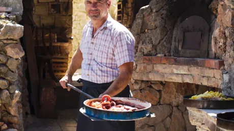 A man holding a large pan of food