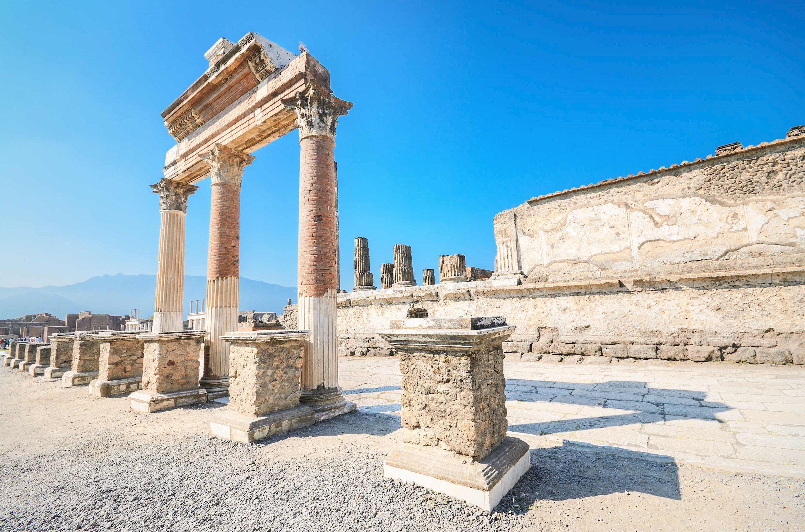Ruins of Temple of Jupiter in Pompeii with tall stone columns