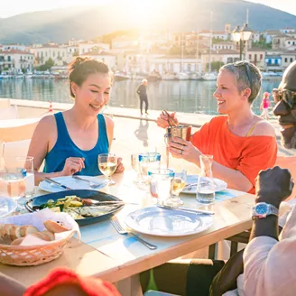 Guests enjoying a waterfront dinner at Galaxidi, Greece