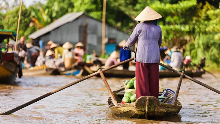 Woman on rowing boat in Mekong Delta, Vietnam
