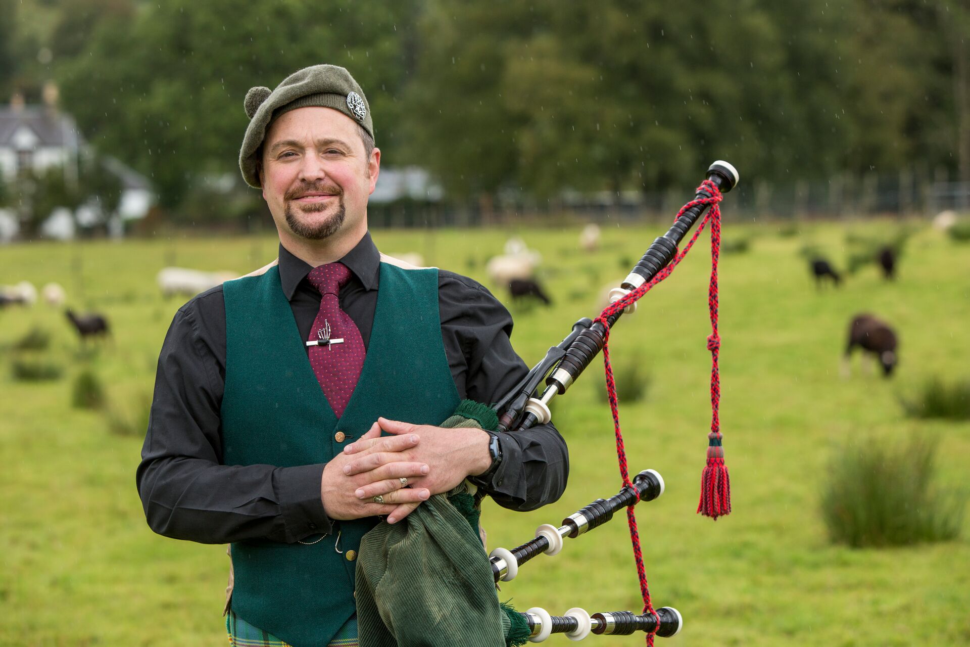Gregor Wood from Ledard Farm wearing traditional Scottish clothes and holding pipes in Scotland