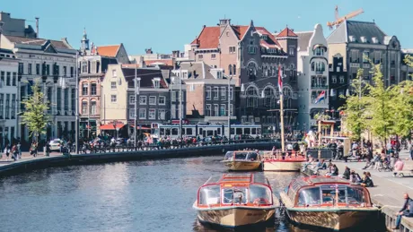 Boats afloat on one of Amsterdam's canals