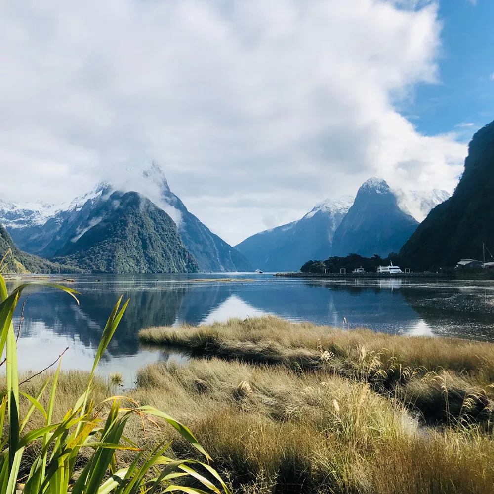 Lake by mountains against sky in New Zealand
