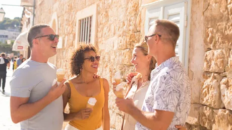People eating ice cream and smiling on a street in Hvar, Croatia