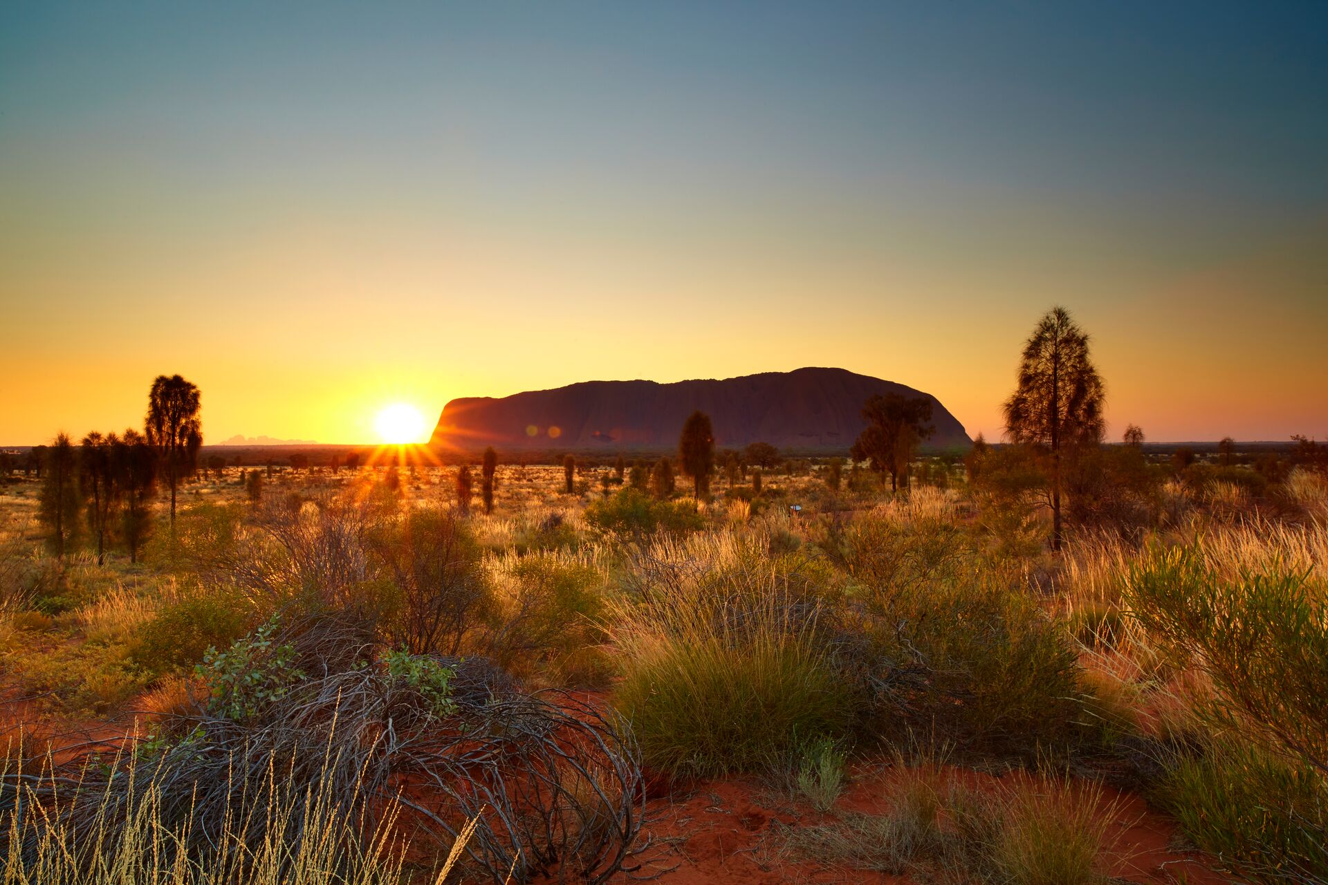 Uluru in front of the sun, Northern Territory, Australia