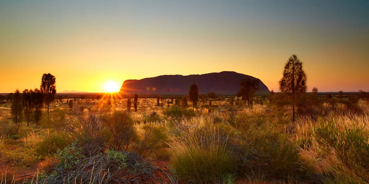 Uluru in front of the sun, Northern Territory, Australia
