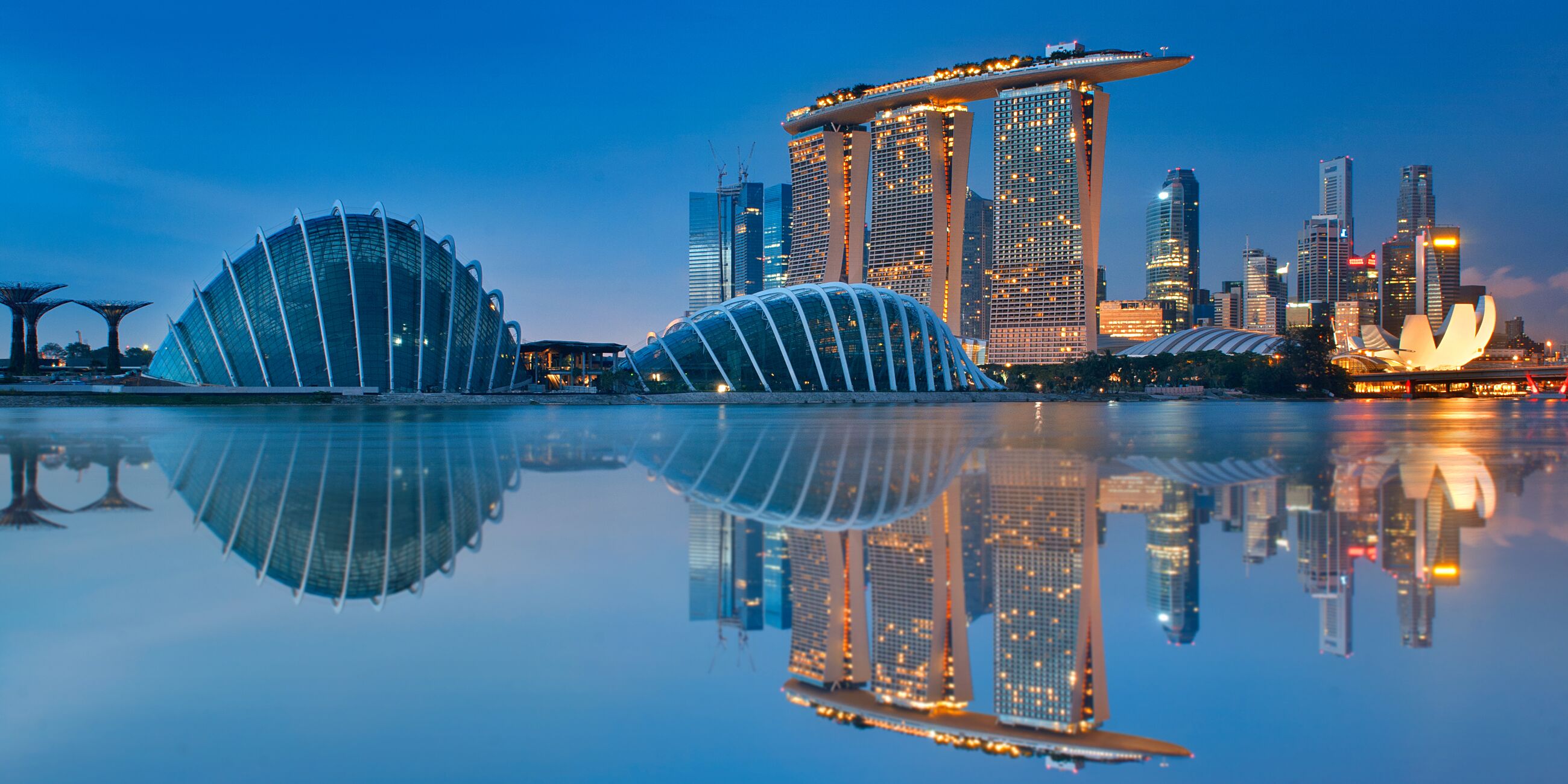 Reflections of modern buildings in water a night, Gardens By The Bay, Singapore