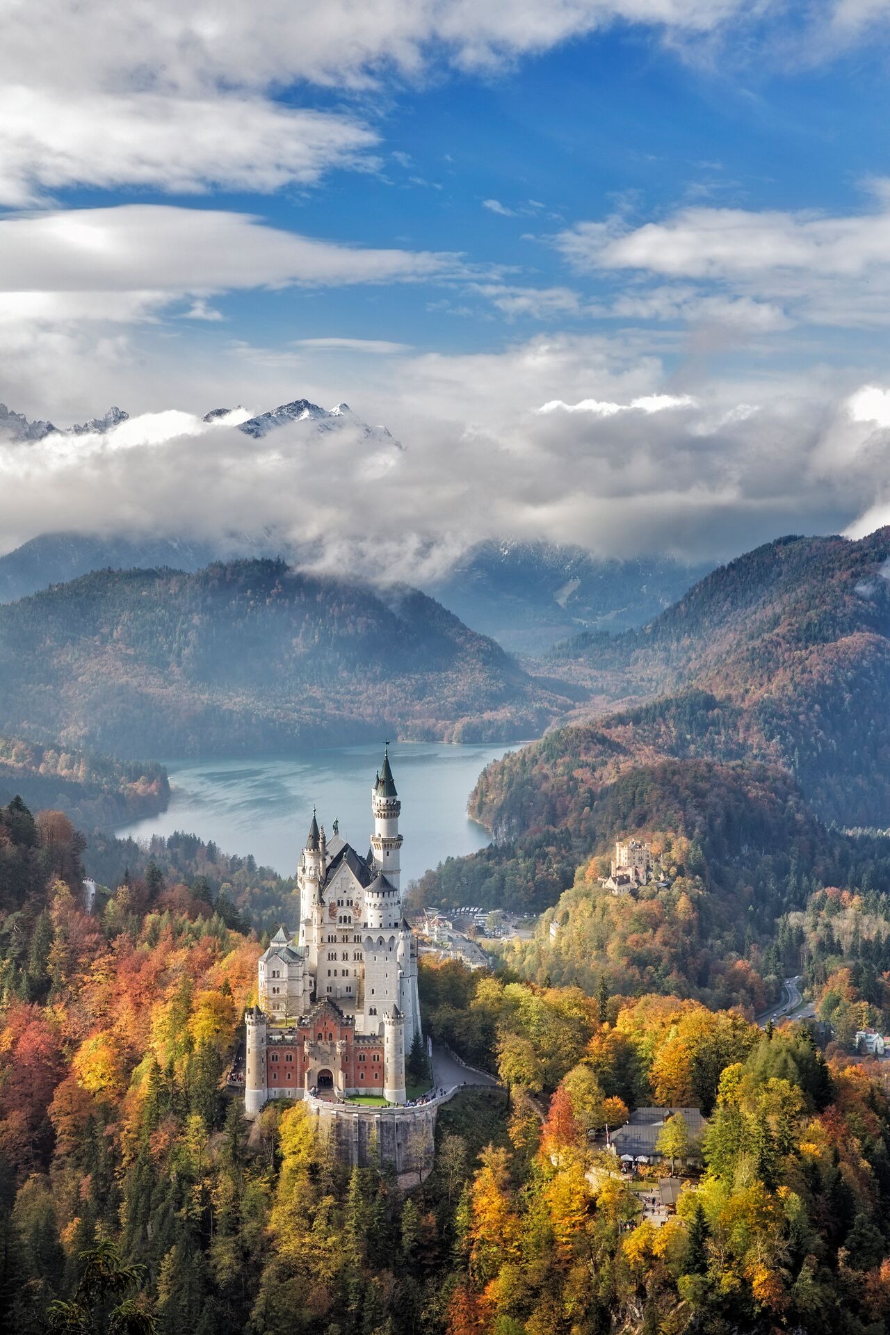 Neuschwanstein Castle in Germany surrounded with autumn forest