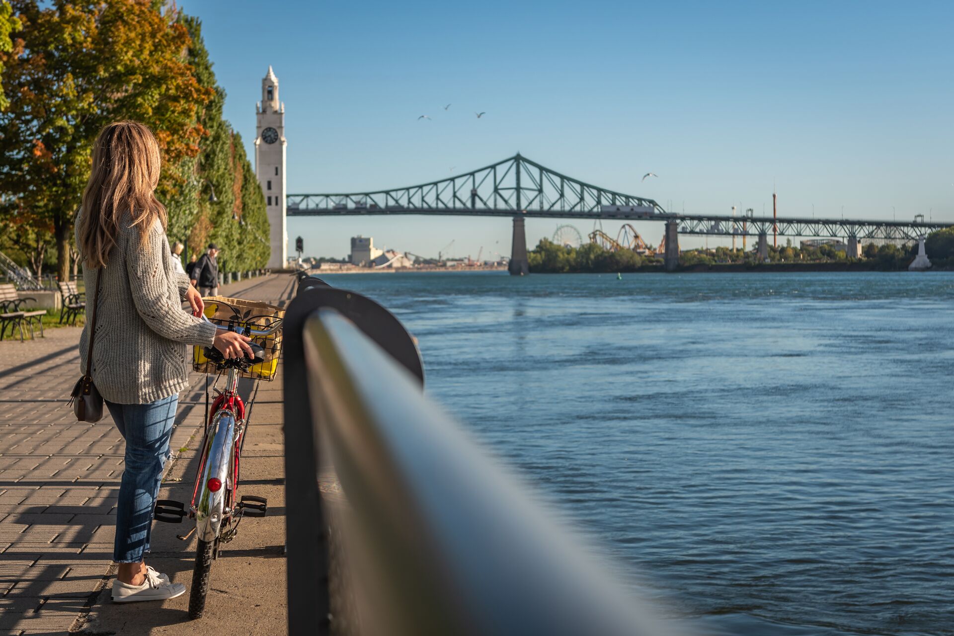 Woman biking in Montreal with the Jacques Cartier Bridge in the background