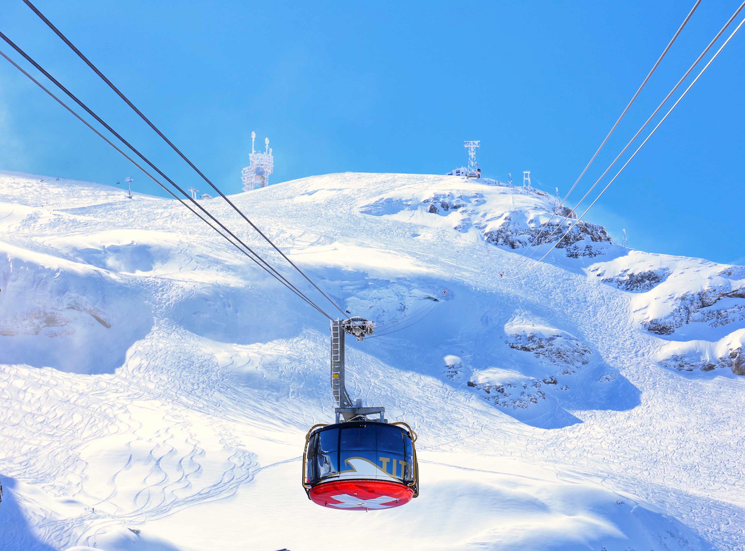 Cable car ascending snowy slopes of Mount Titlis in Swiss Alps, Switzerland