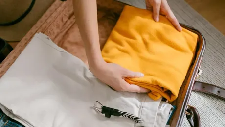 Woman Packing A Suitcase