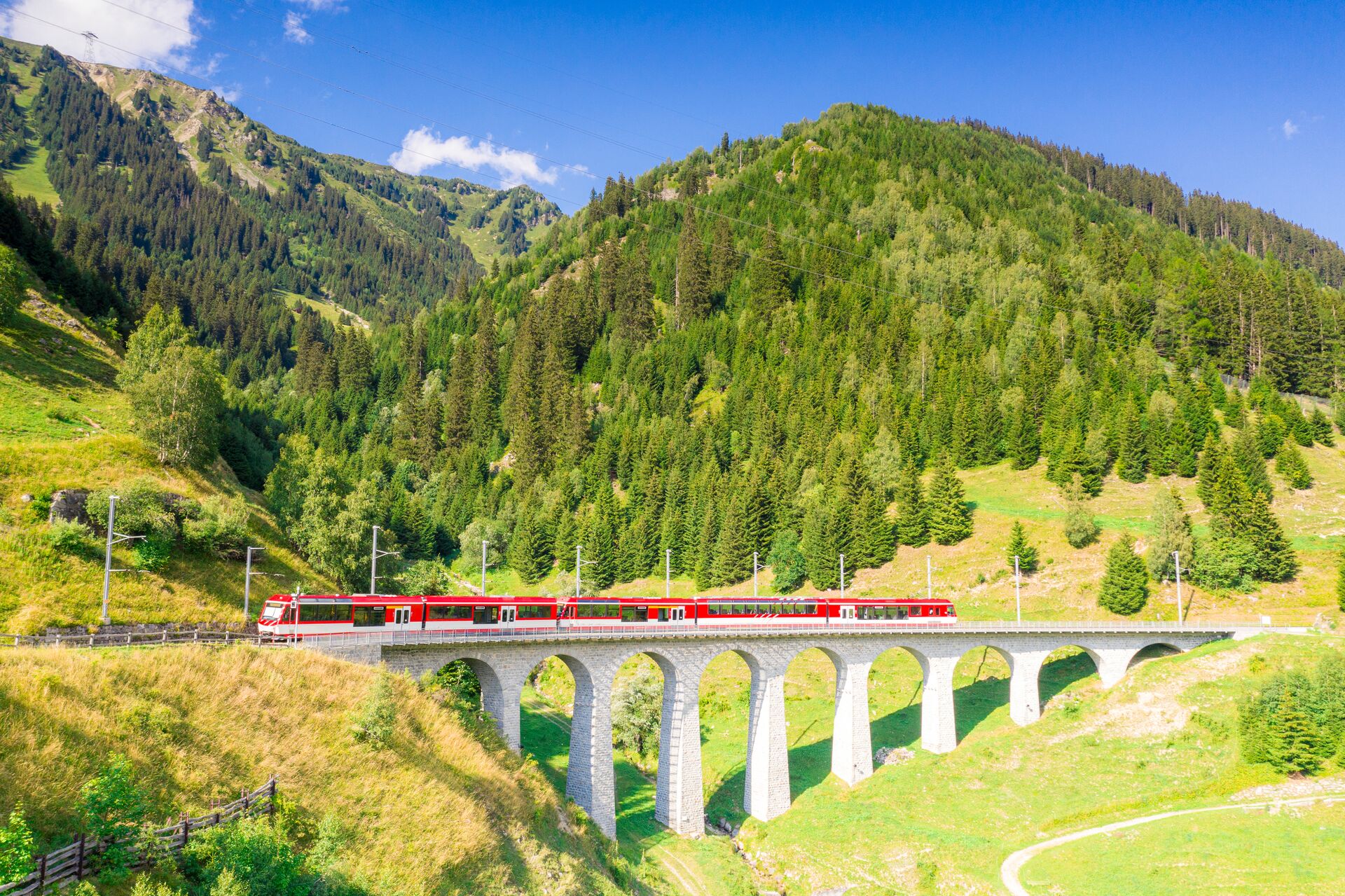 Glacier Express Train on Tujetsch Viaduct during summer in Switzerland