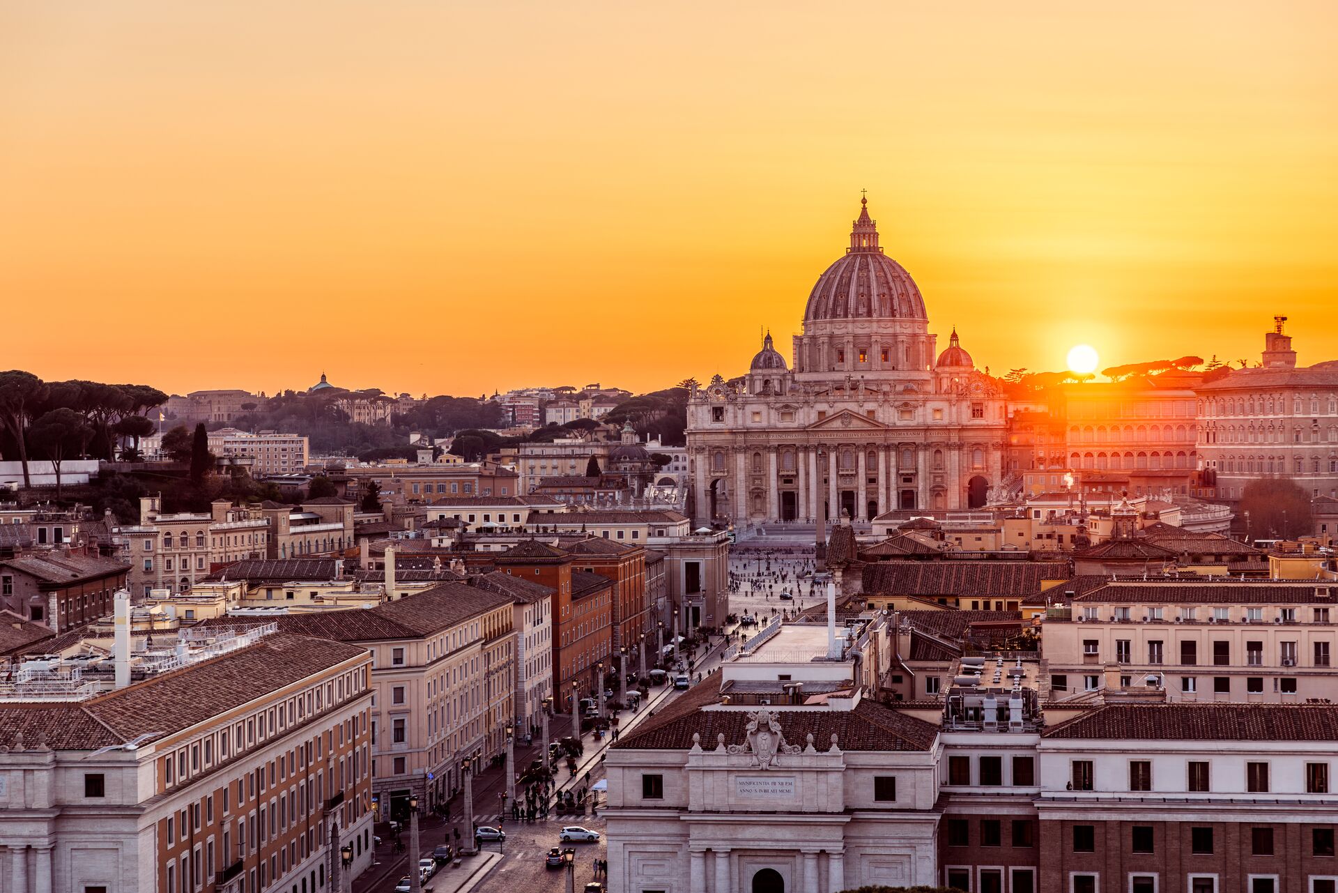 The sun is setting over St. Peter's Basilica, Rome
