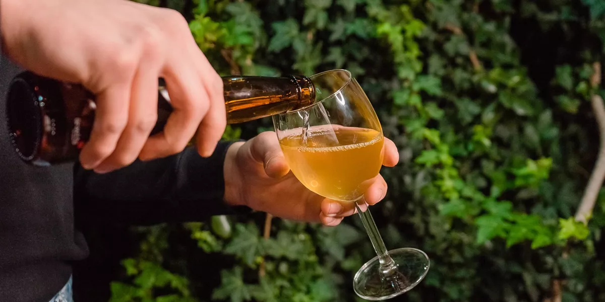 Close-up of someone pouring cider