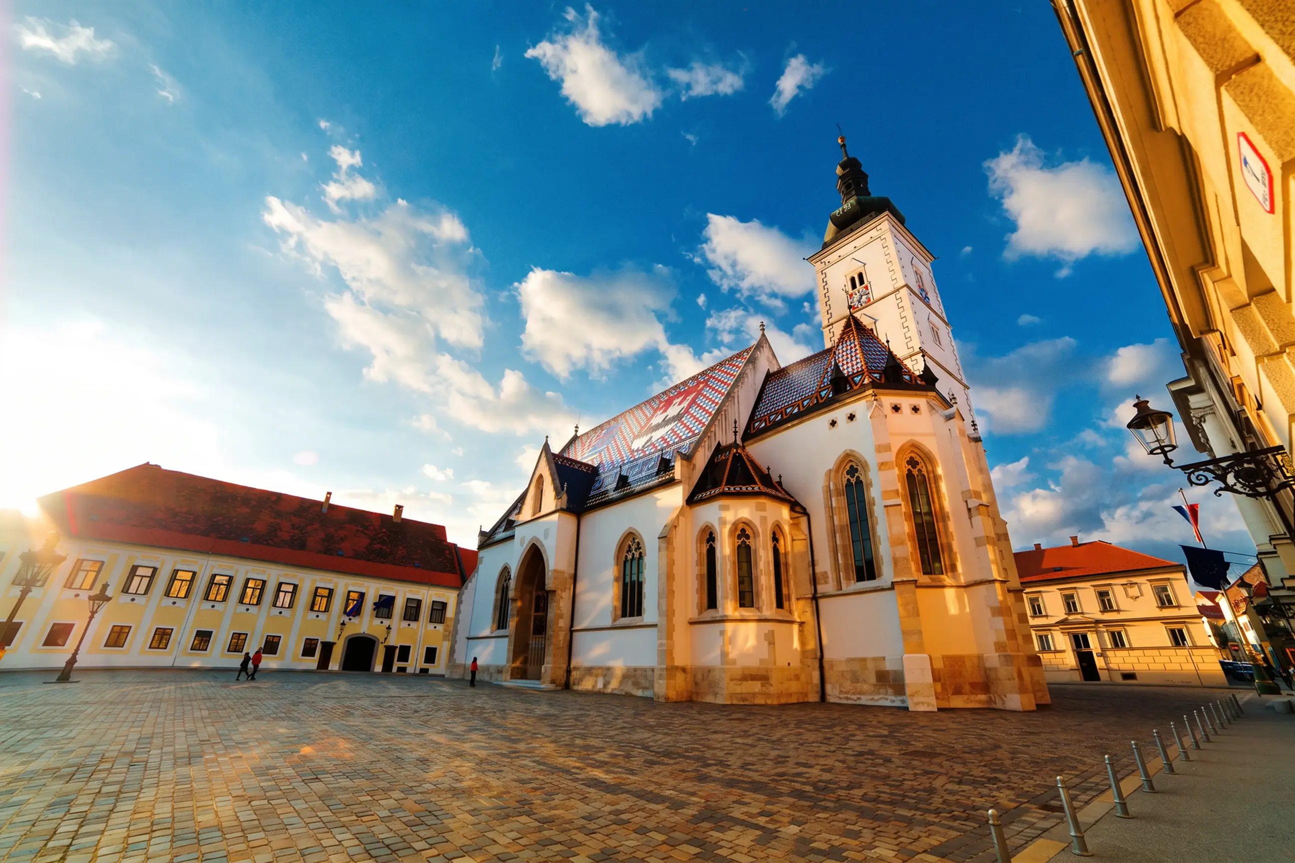 day-hero-sunlit-st-marks-church-zagreb-croatia.webp