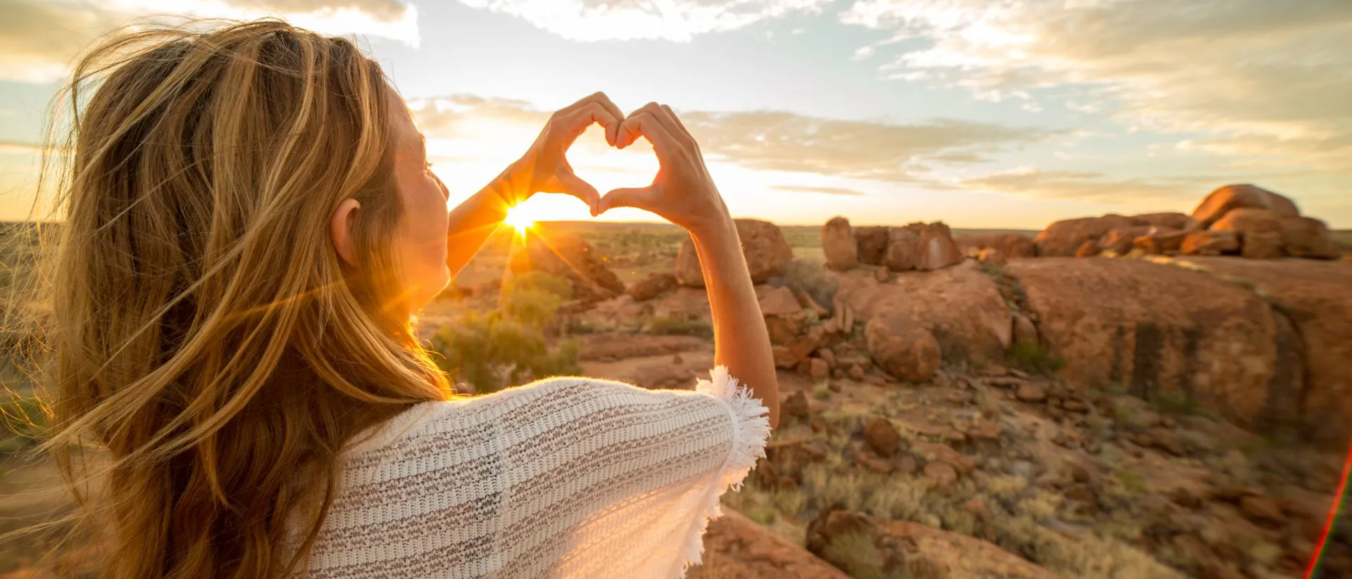 A woman making a heart shape with her hands