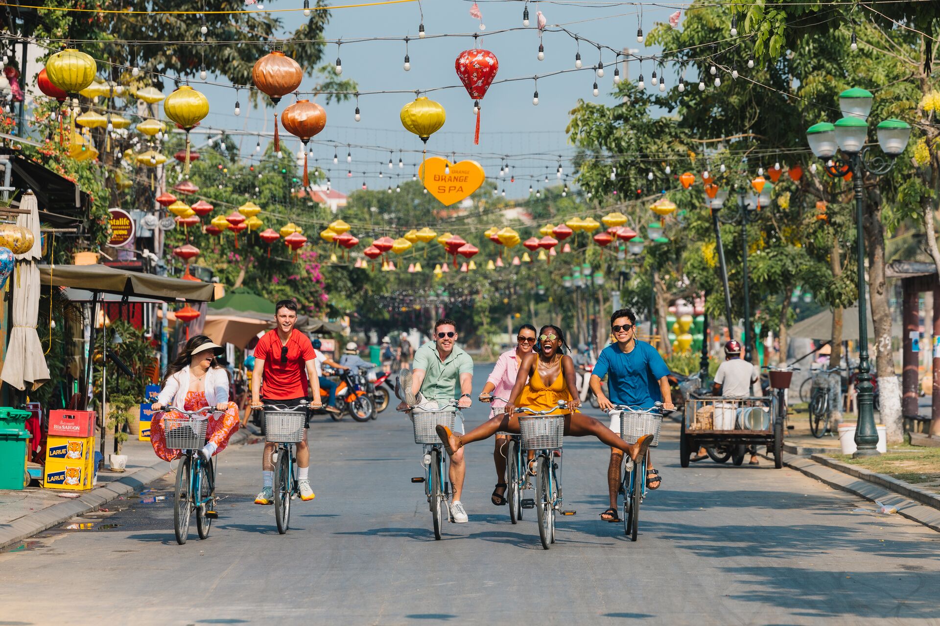 A group of people riding bikes down a street in Vietnam