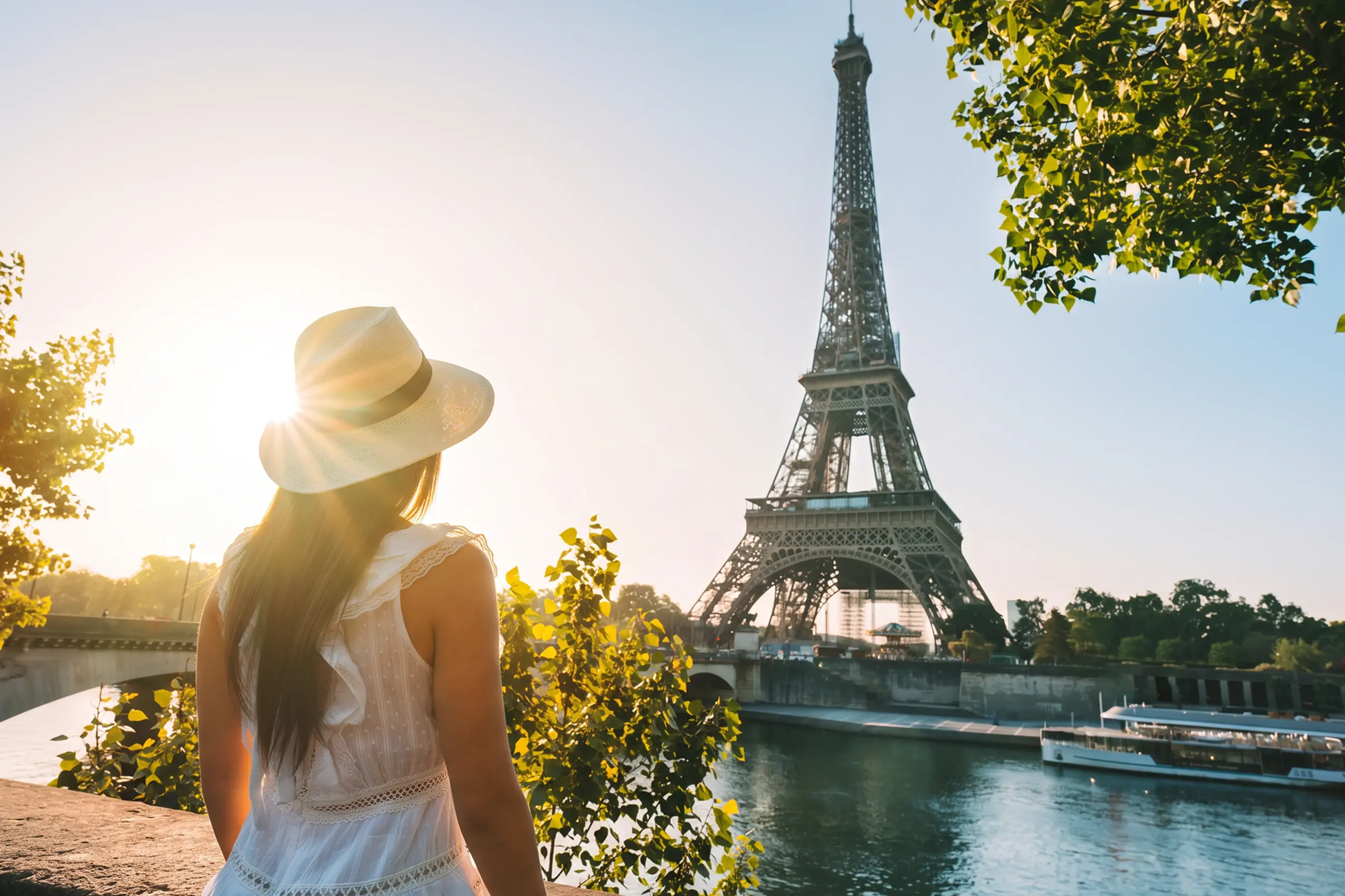 day-hero-woman-in-hat-looking-at-eiffel-tower-paris-france.webp