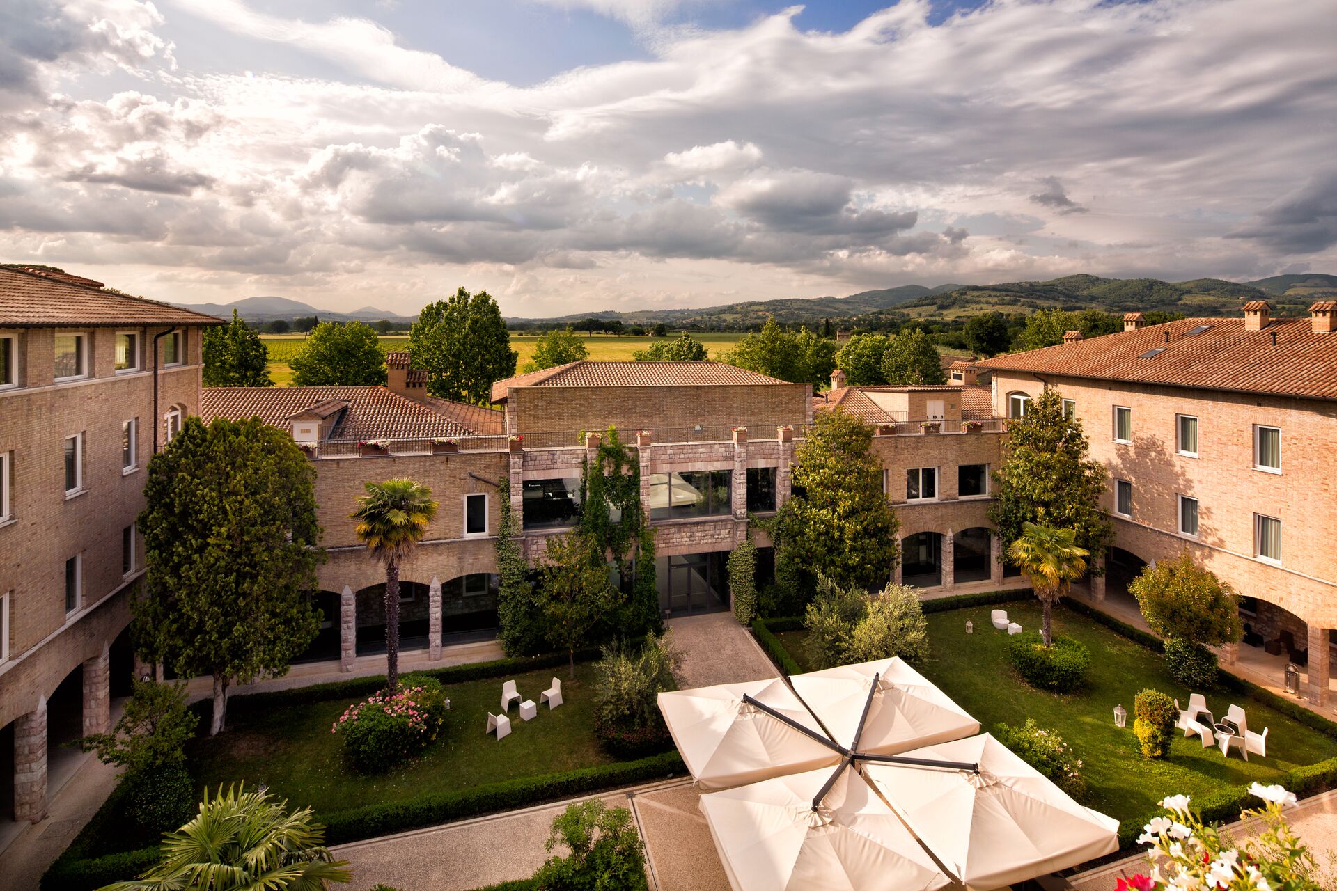 Green piazza of Hotel Cenacolo in Assisi, Italy 