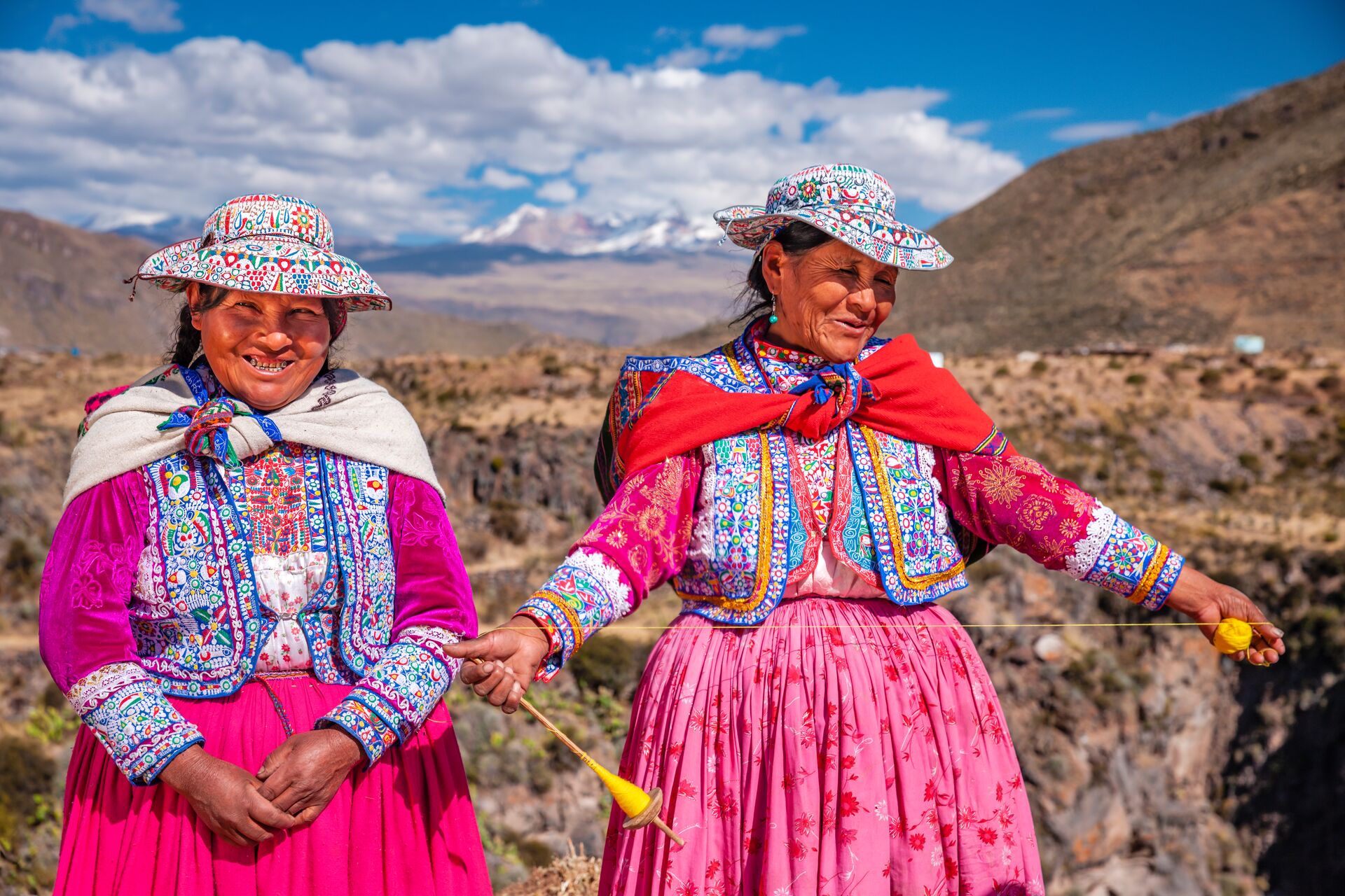 Peruvian women spinning wool by hand near Colca Canyon, Peru