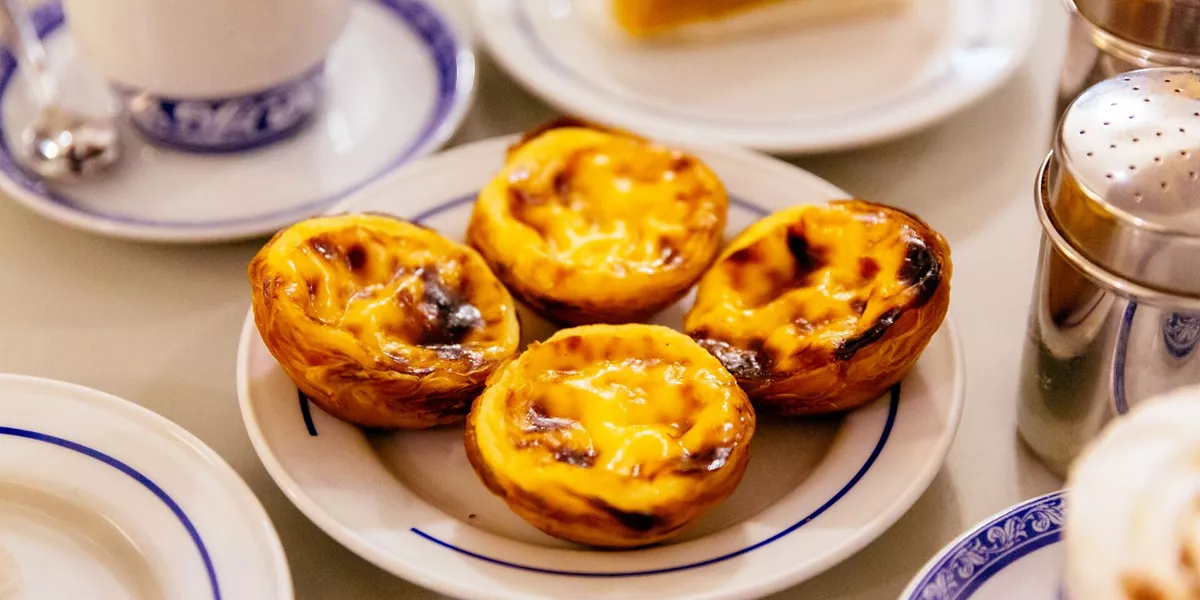 Pasteis de nata, traditional Portuguese pastry on a plate