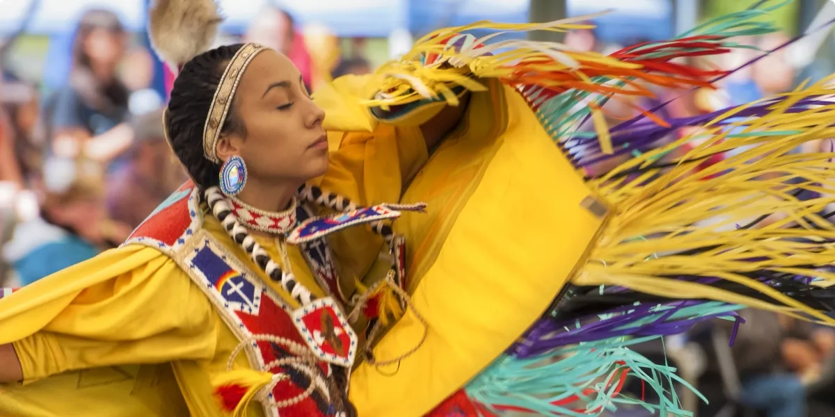 Lady dancing in traditional yellow dress
