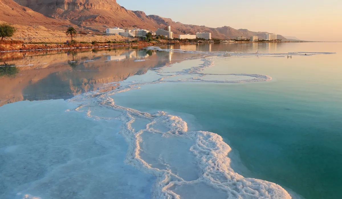 The Dead Sea with buildings and a mountain in the background