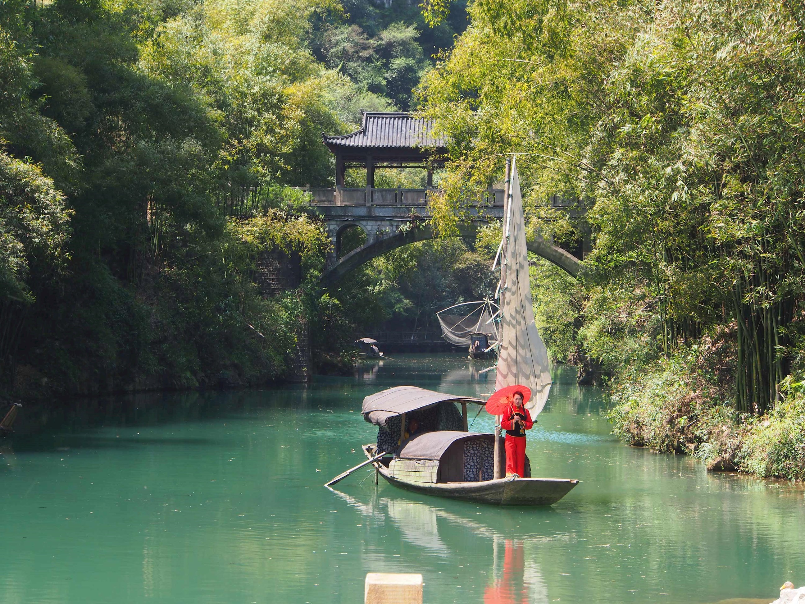 Woman in traditional dress sailing down the Yangtze River in China