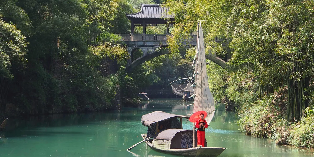 Woman in traditional dress sailing down the Yangtze River in China