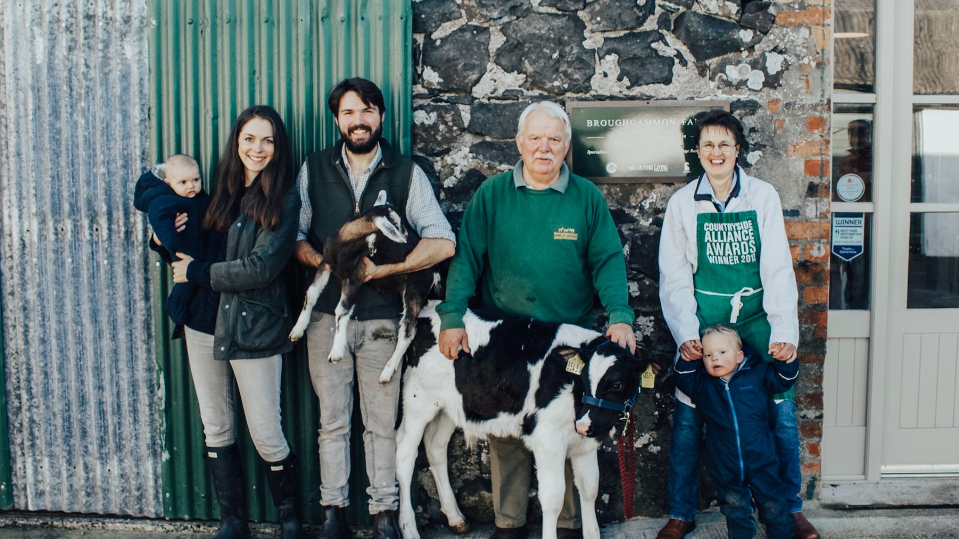 The Cole Family standing with a cow at Broughgammon Farm in Ireland