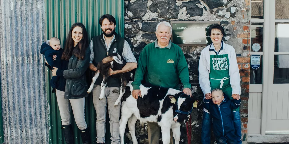 The Cole Family standing with a cow at Broughgammon Farm in Ireland