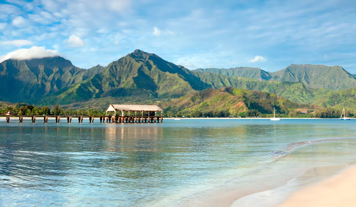 Hanalei Bay beach in Kauai with a pier and mountains in the background, Hawaii