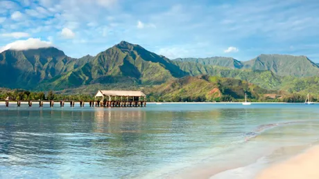 Hanalei Bay beach in Kauai with a pier and mountains in the background, Hawaii