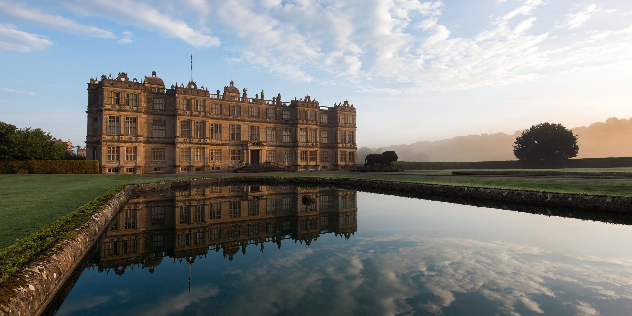 A large stately home, Warminster Longleat House, reflected in water, Wiltshire, England