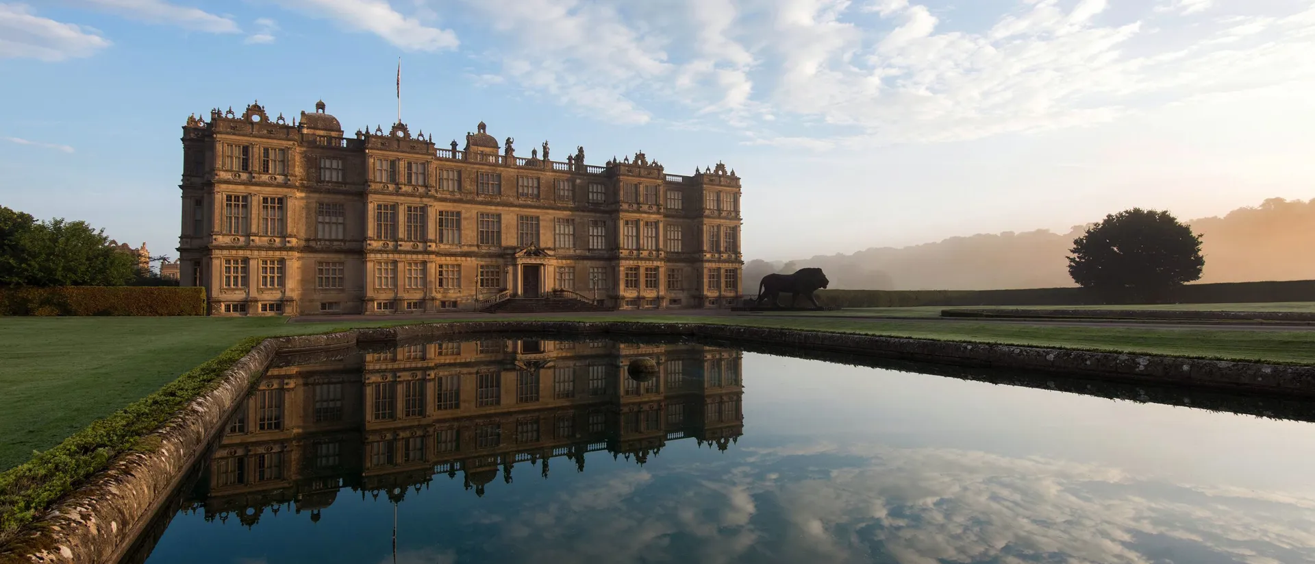 A large stately home, Warminster Longleat House, reflected in water, Wiltshire, England