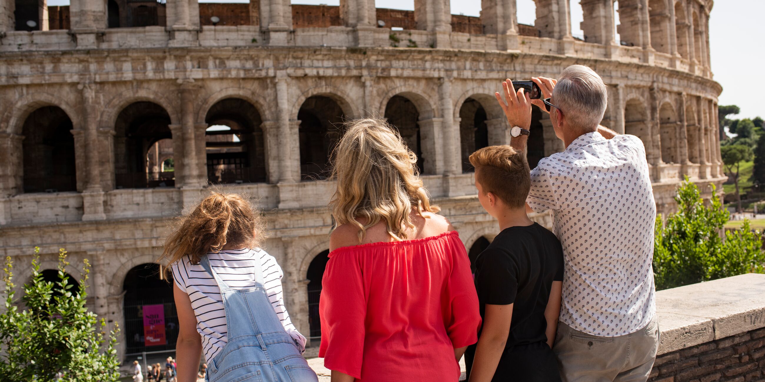 Family looking at the Colosseum while on a family holiday in Rome, Italy