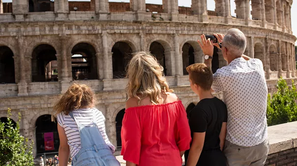 Family looking at the Colosseum while on a family holiday in Rome, Italy