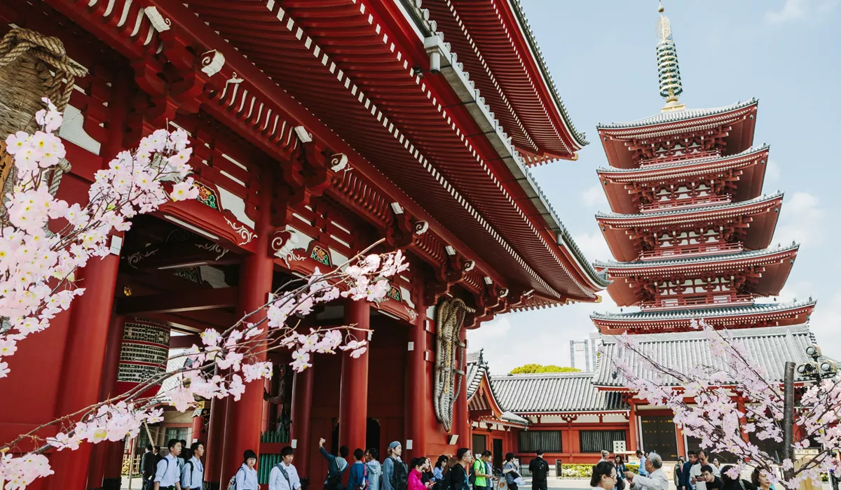People standing in front Sensoji Buddhist temple in Taitō, Japan