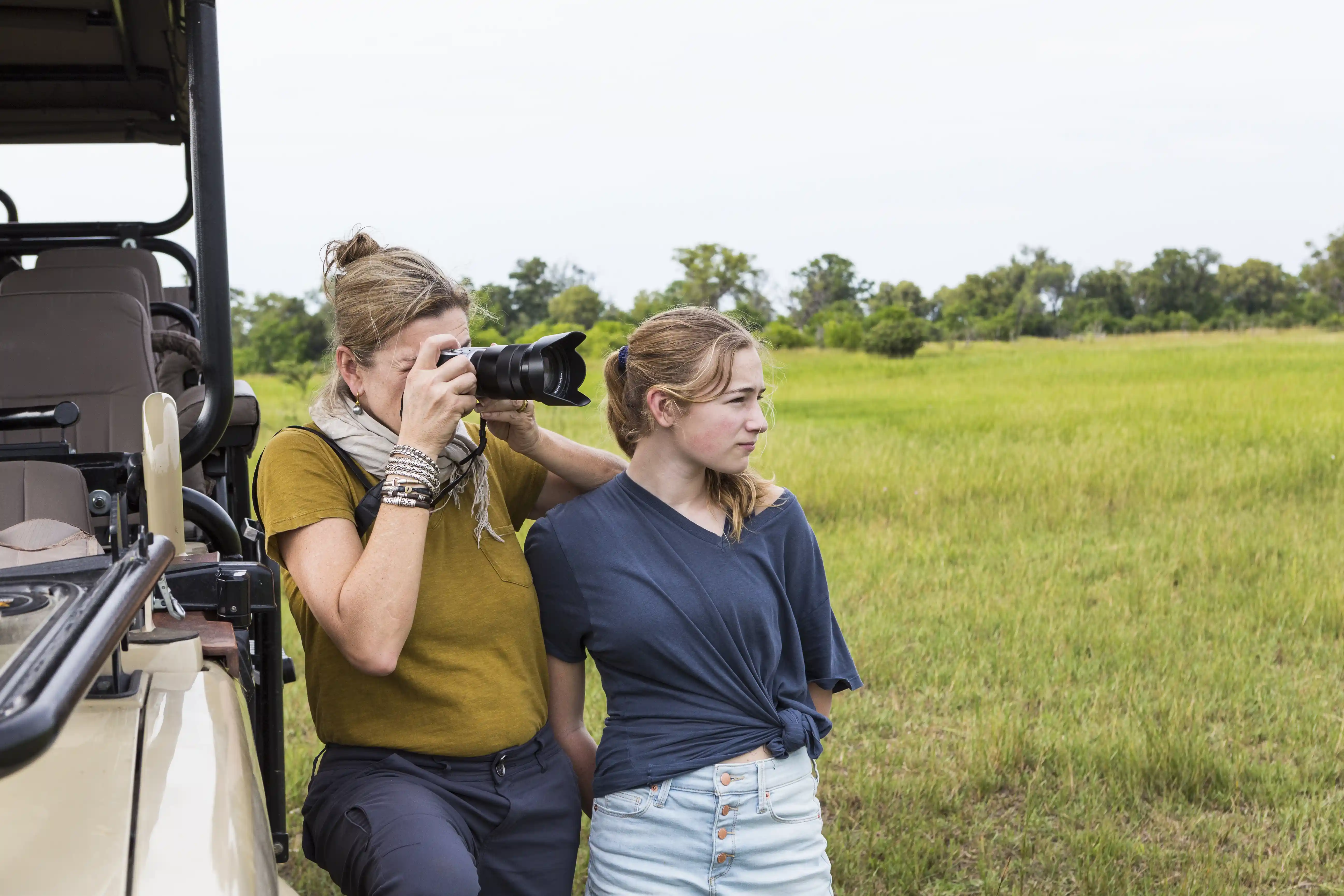 Mother And Teen Daughter Taking Photographing On Safari