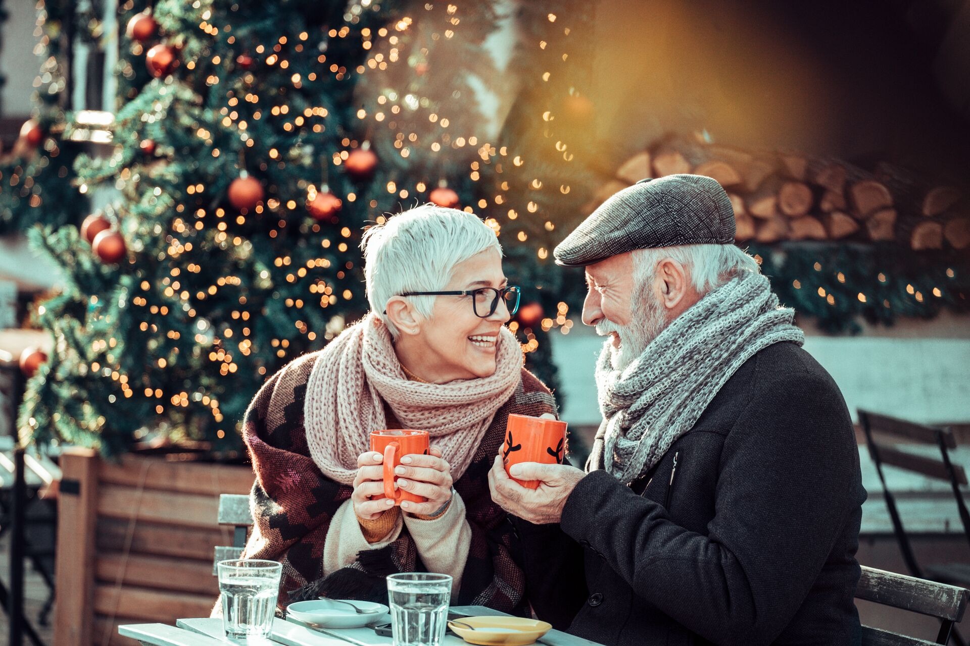 senior-couple-during-christmas-shopping-sit-at-sidewalk-cafe-for-warming-up.jpeg