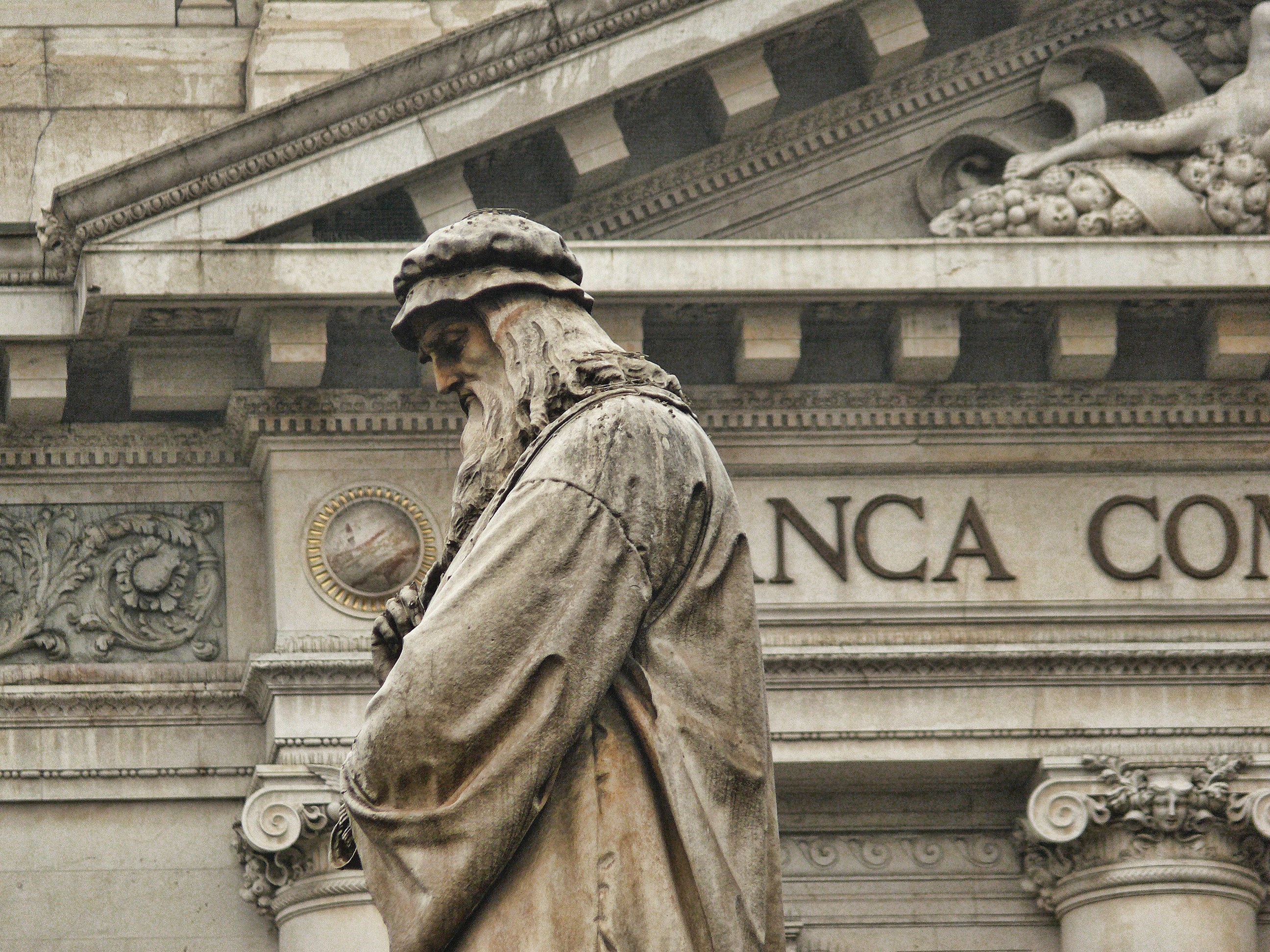 A close-up of the Monument to Leonardo da Vinci in Milan, Italy