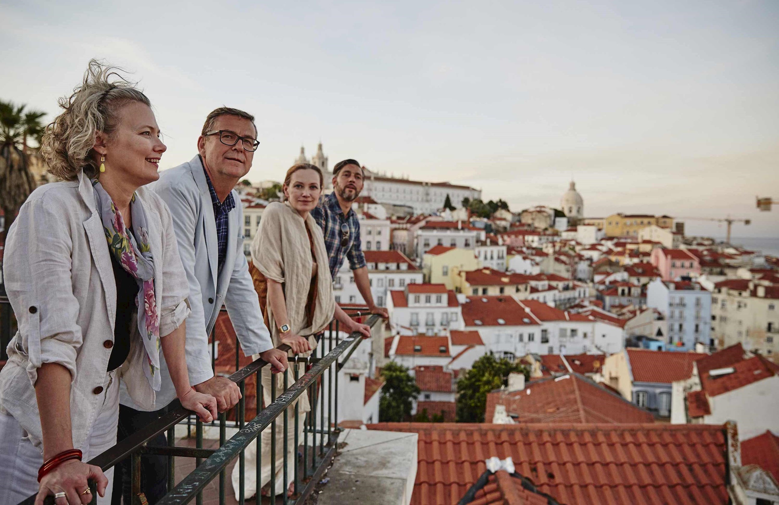 Travellers looking over a balcony in Lisbon, Portugal
