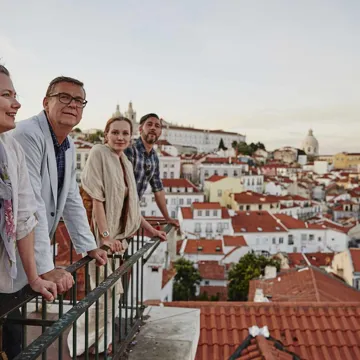 Travellers looking over a balcony in Lisbon, Portugal