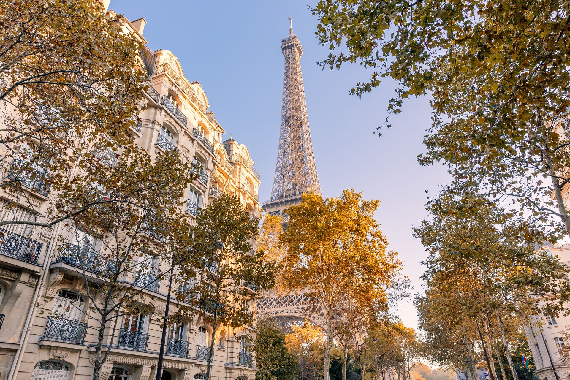 The Eiffel Tower with traditional town houses in the foreground during autumn in Paris, France