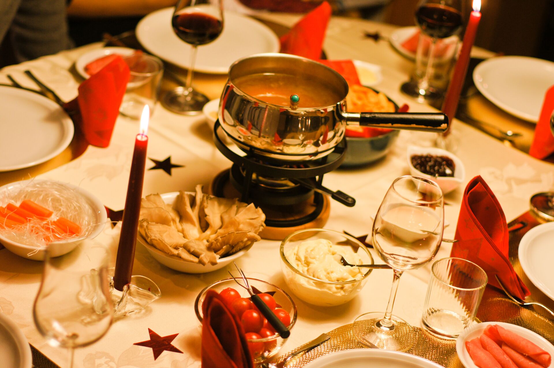 A candlelit dinner featuring food, crockery and glassware