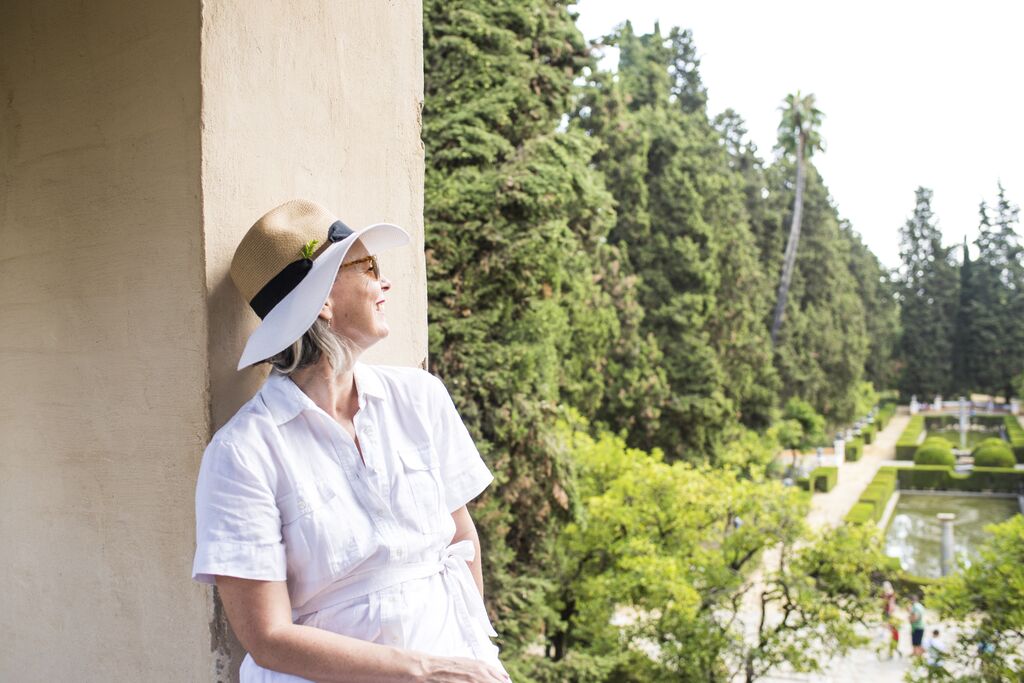 Lady looking out a view of a garden in Seville Spain