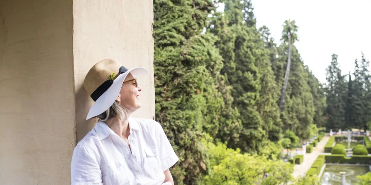 Lady looking out a view of a garden in Seville Spain