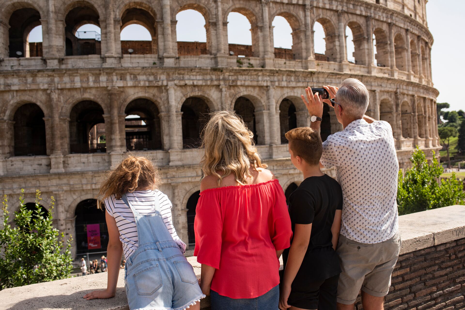 Family looking at the Colosseum in Rome, Italy while on a family holiday
