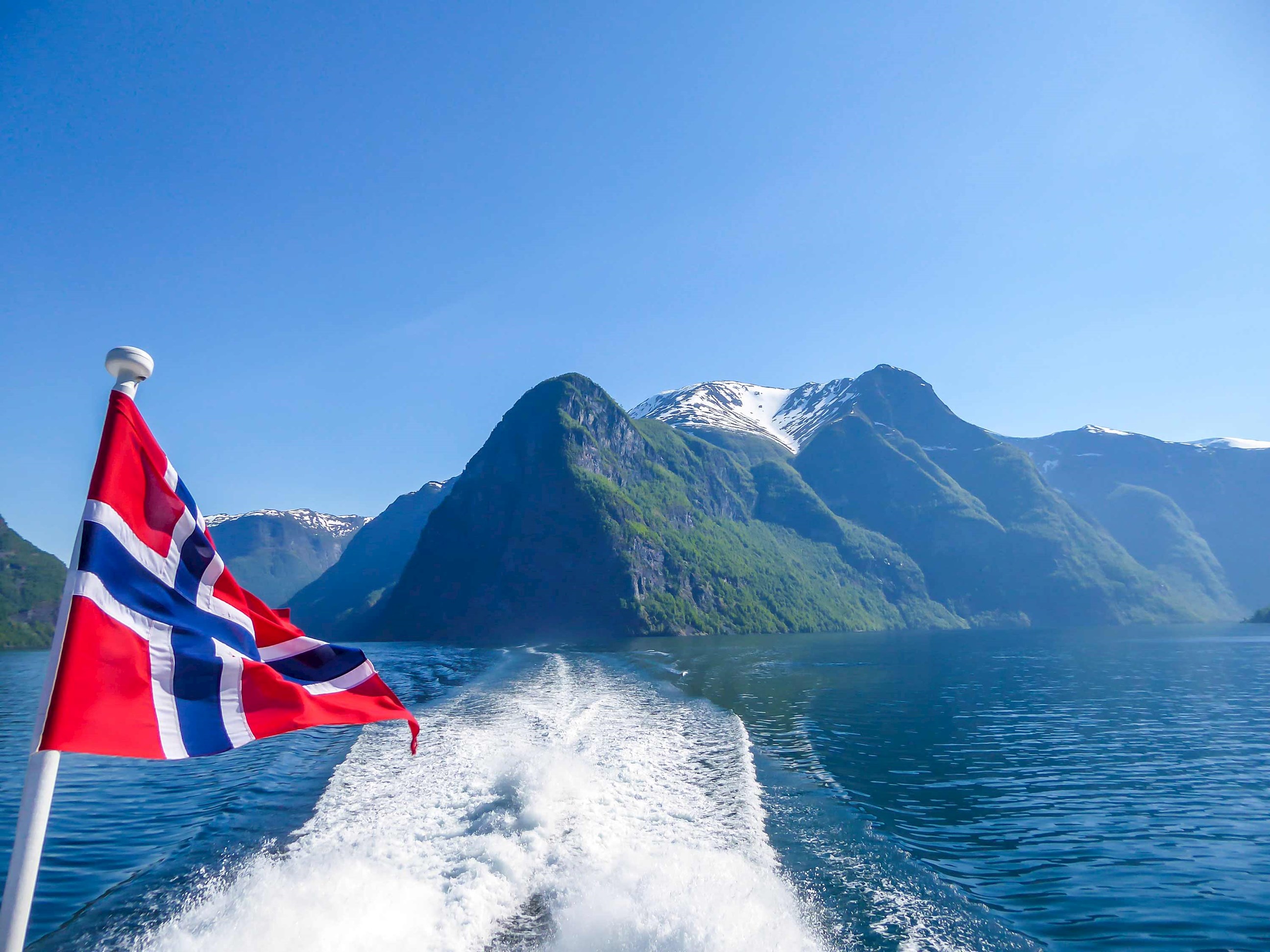 A Norwegian flag sailing over Sognefjord 