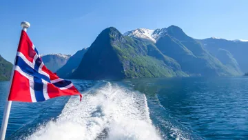A Norwegian flag sailing over Sognefjord
